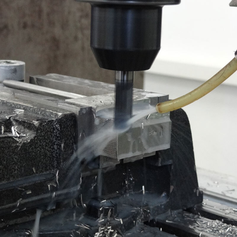 A metal being drilled using heavy machinery